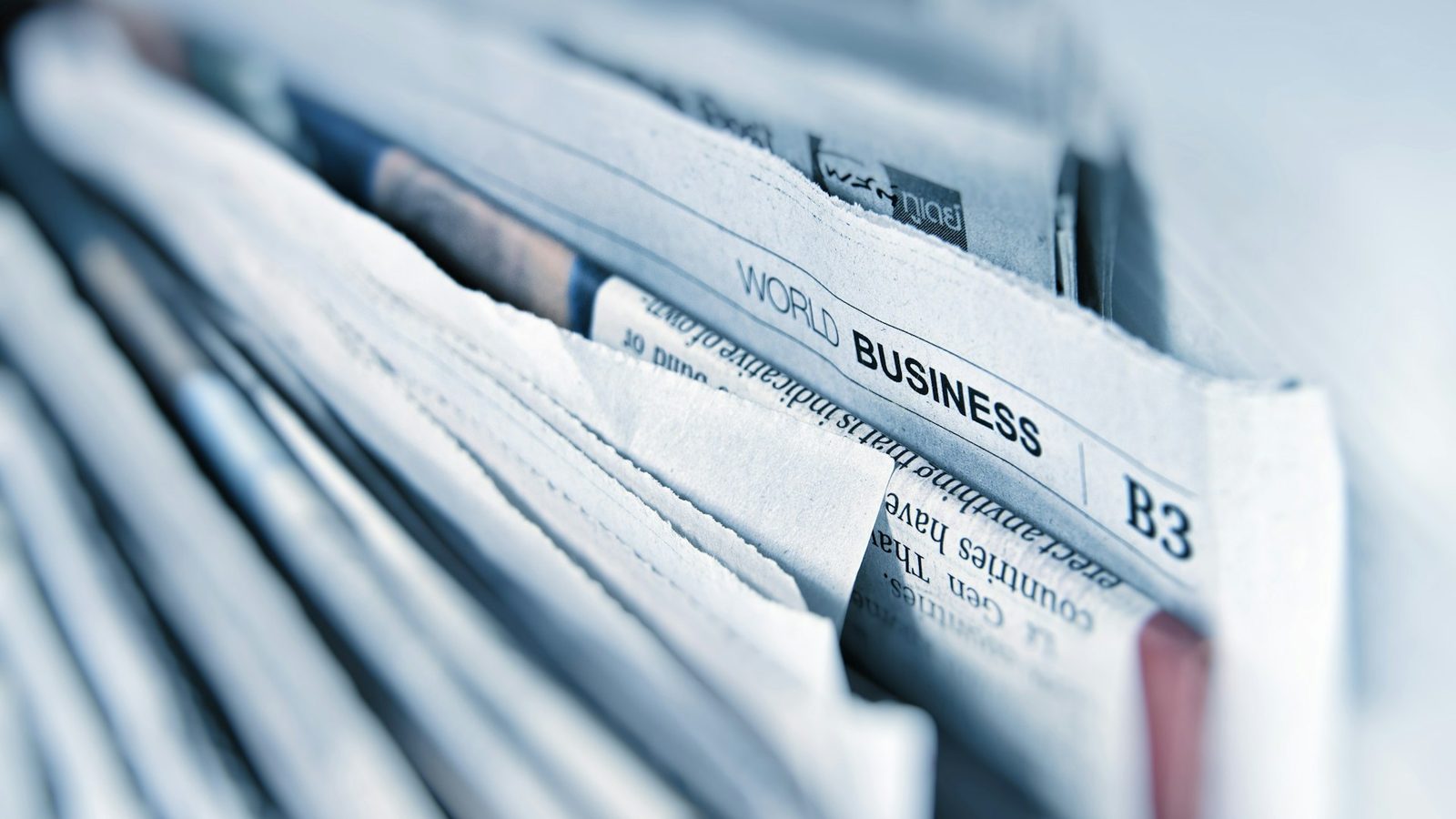 World business newspaper stacked on a desk